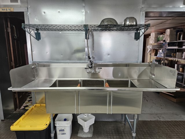 Closer image of the catering kitchen's three-compartment prep sink.