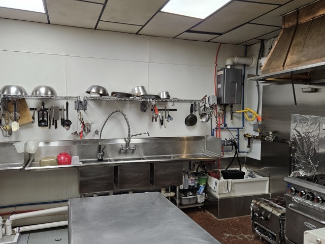 Image of the cooking kitchen's three-compartment sink.