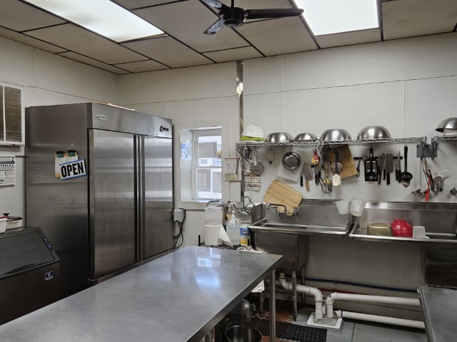 Image of the cooking kitchen's sink and refrigerator.